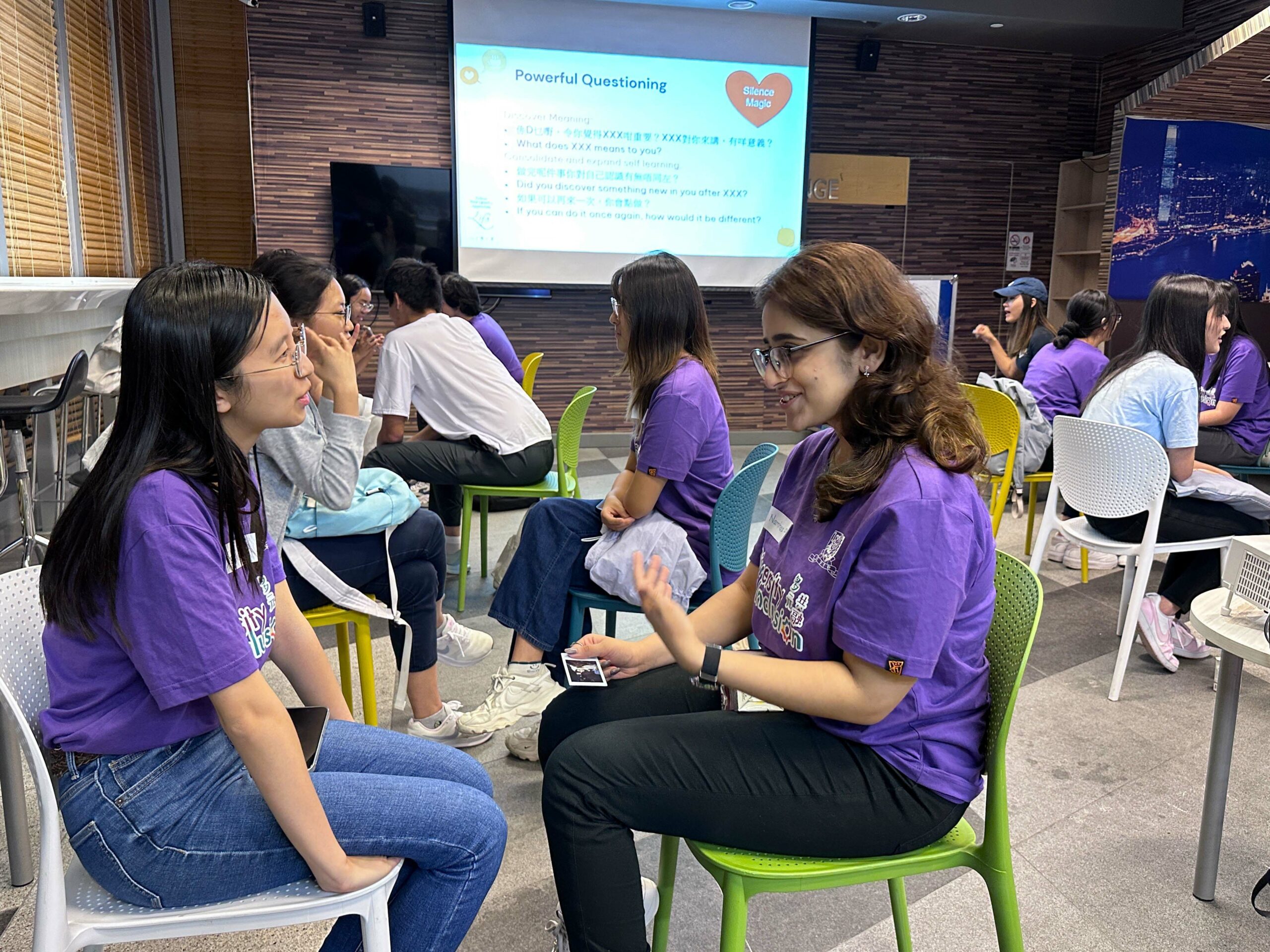 Two ambassadors engage in a focused conversation during the group workshop.