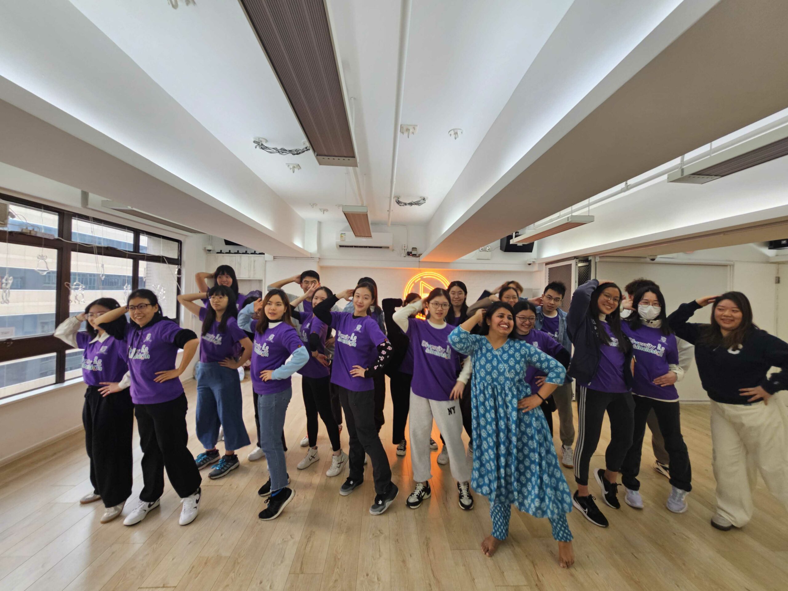 The D&I ambassadors are striking a final pose with the tutor after the Indian dance workshop.